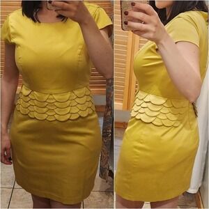 Yellow scalloped sheat dress with zipper closure and cap sleeves.
